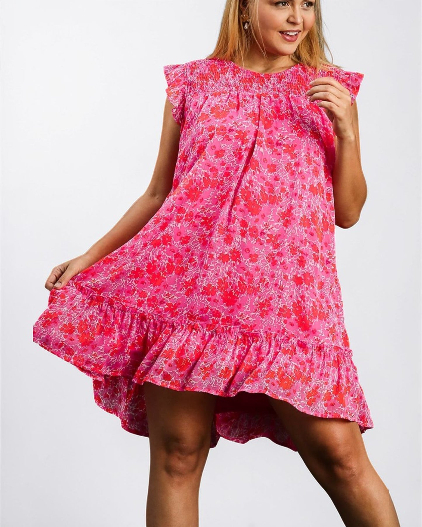 Woman wearing a pink floral dress on a white background