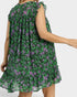 Green floral dress worn by a person on a plain background