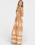 Woman wearing a long, patterned dress on a white background