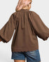 Brown textured blouse worn by a person on a white background