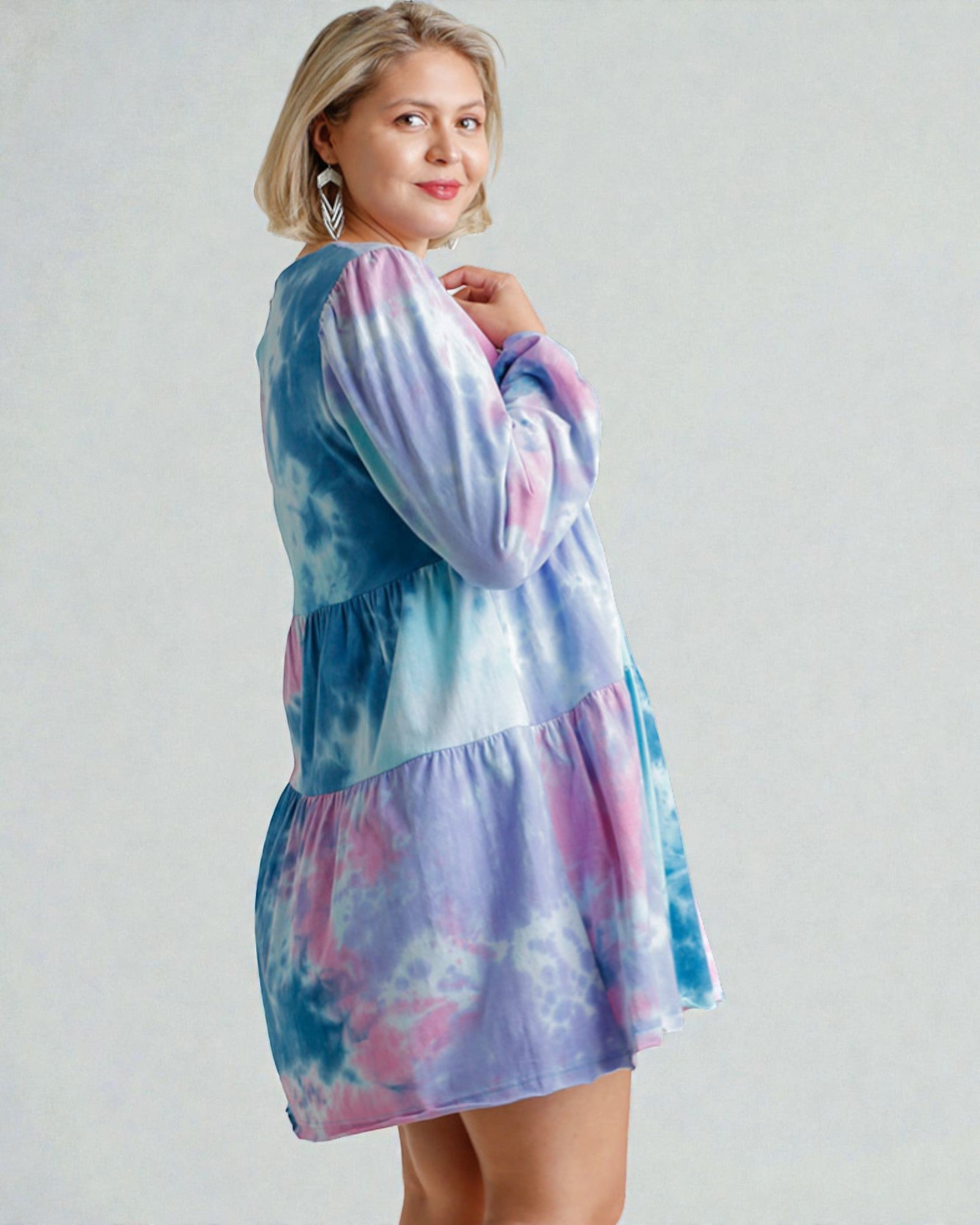 Woman wearing a tie-dye dress with a white background
