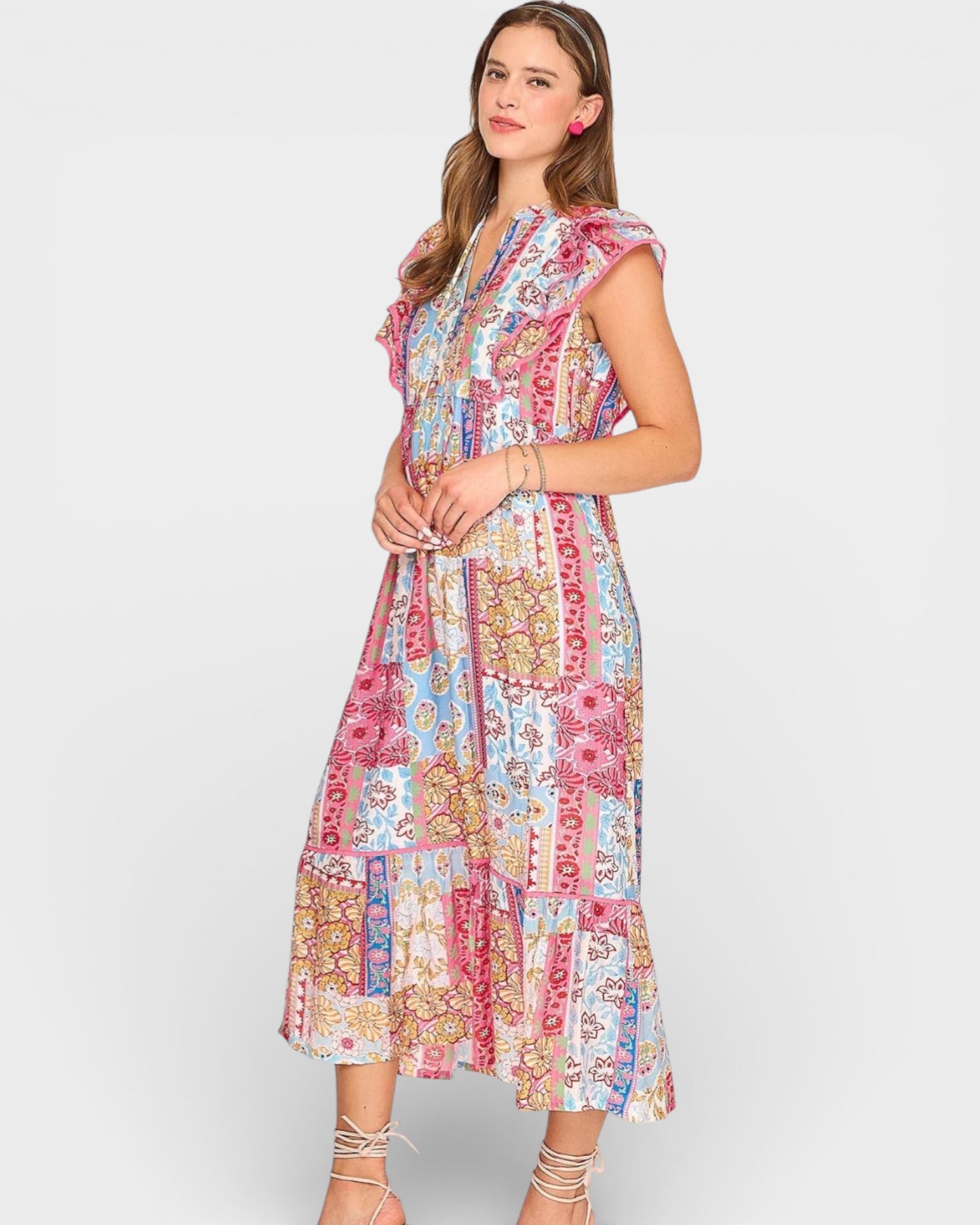 Woman wearing a colorful patterned dress on a white background