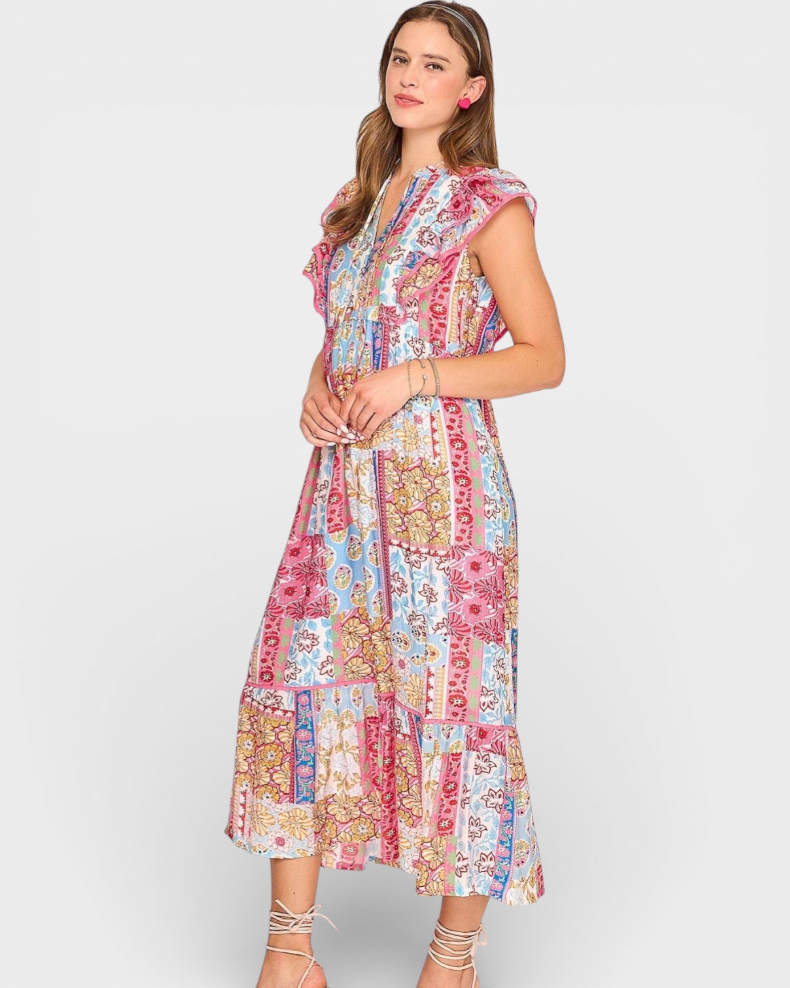 Woman wearing a colorful patterned dress on a white background