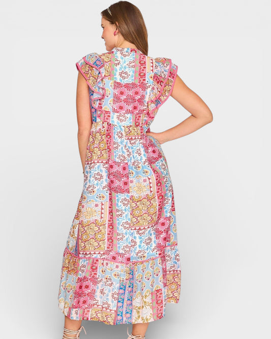 Woman wearing a colorful patchwork dress on a white background