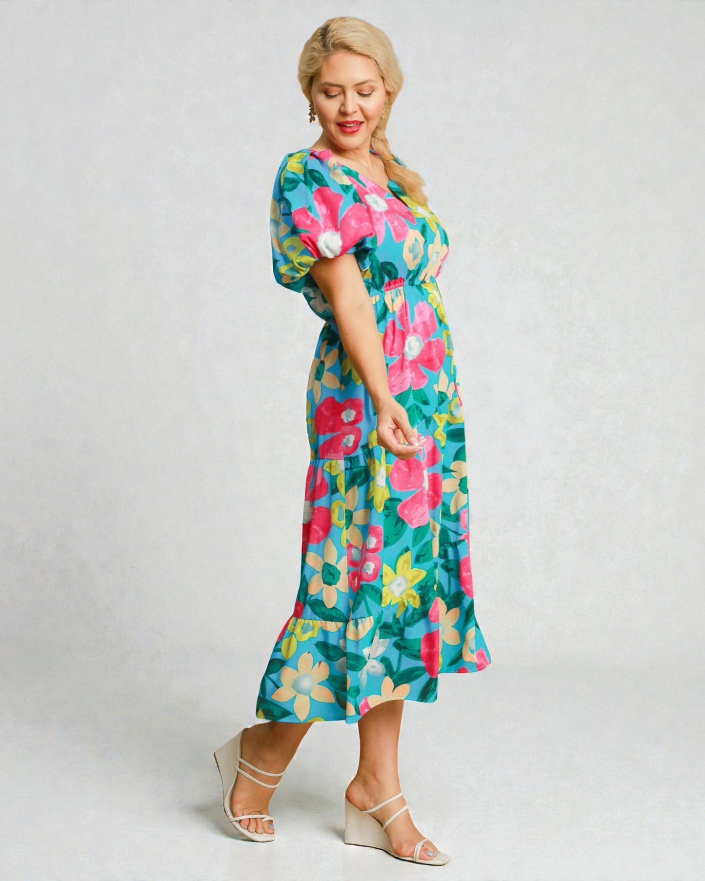 Woman wearing a colorful floral dress on a white background