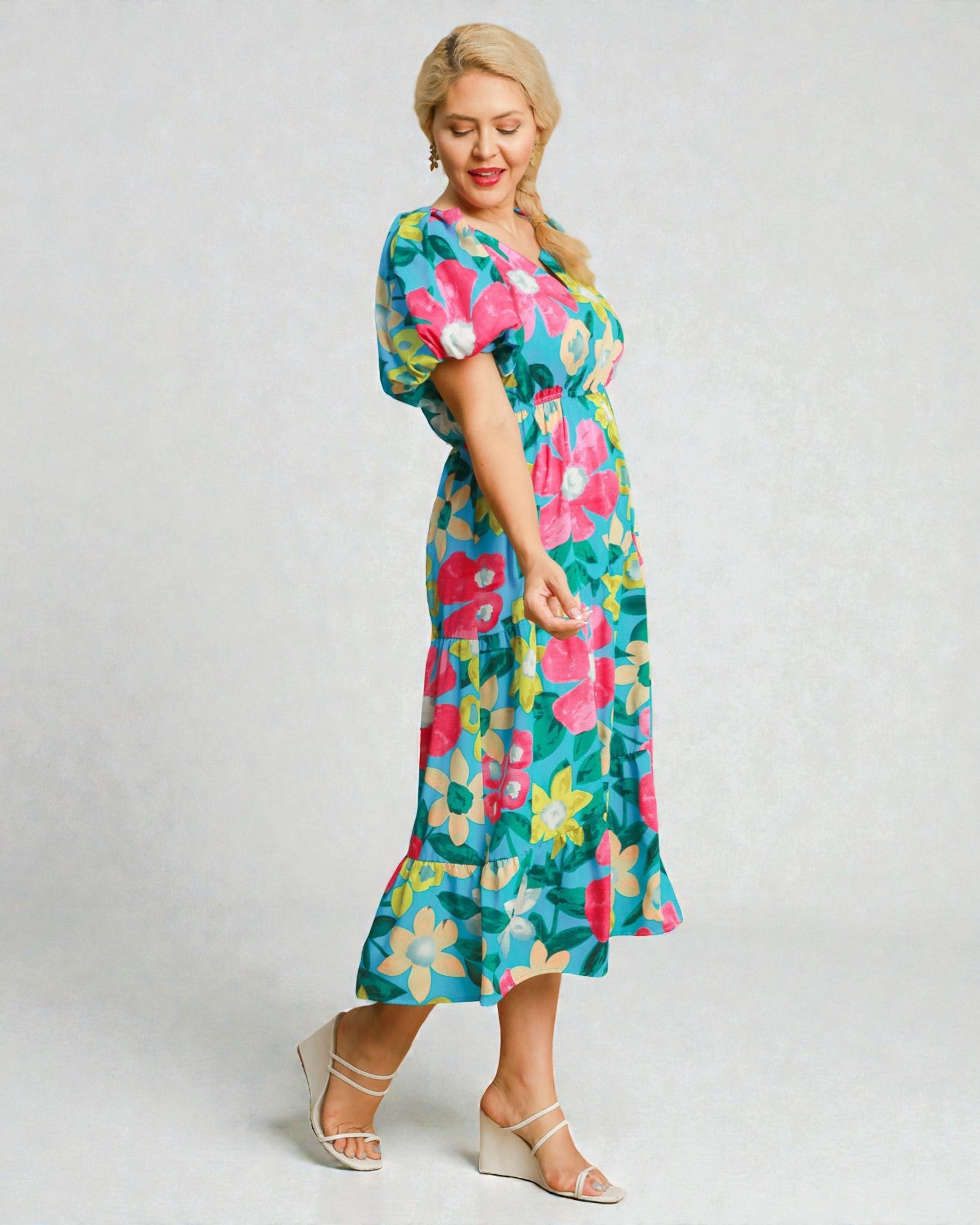 Woman wearing a colorful floral dress on a white background