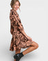 Woman wearing a patterned dress on a white background