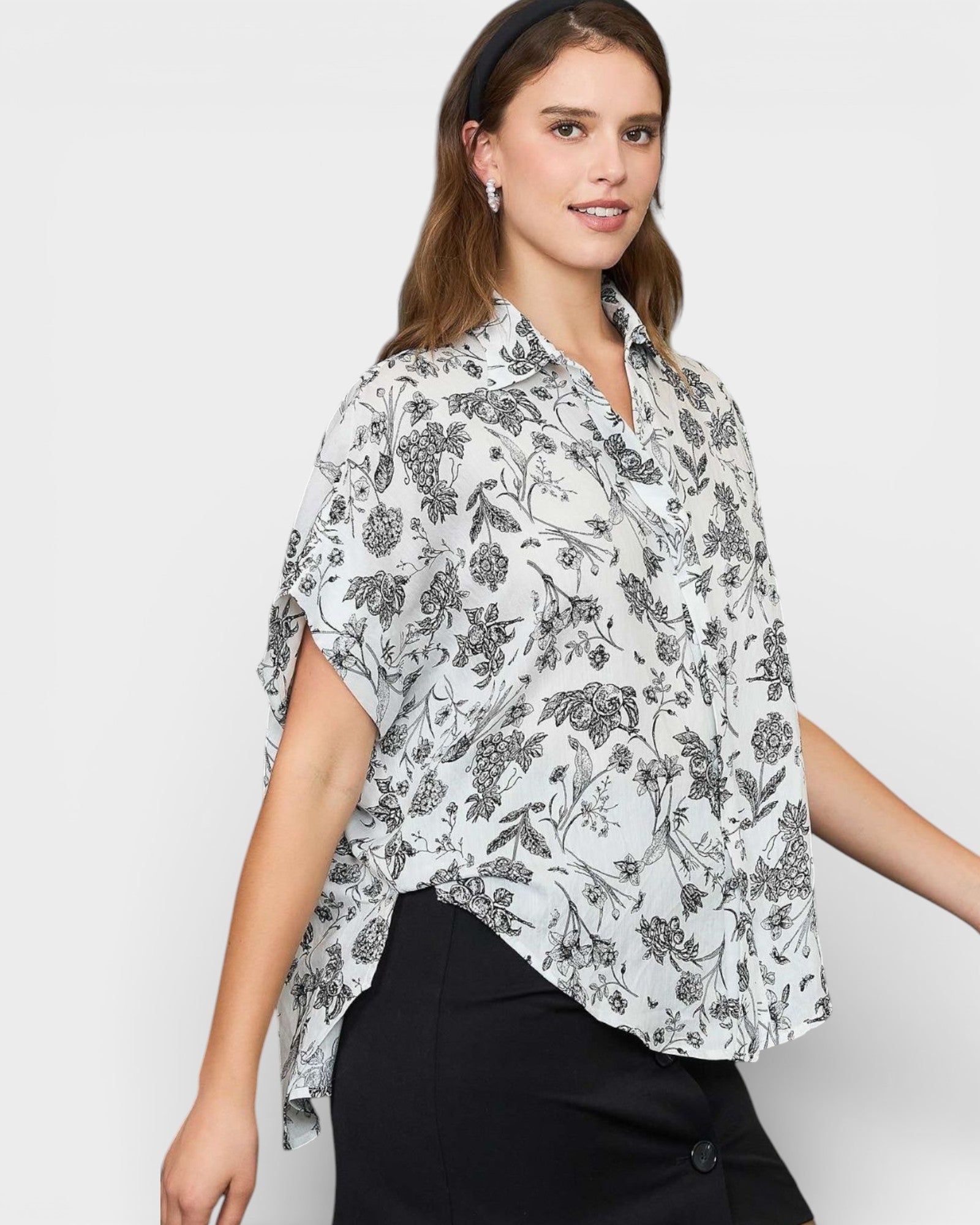 Woman wearing a floral blouse with a plain background