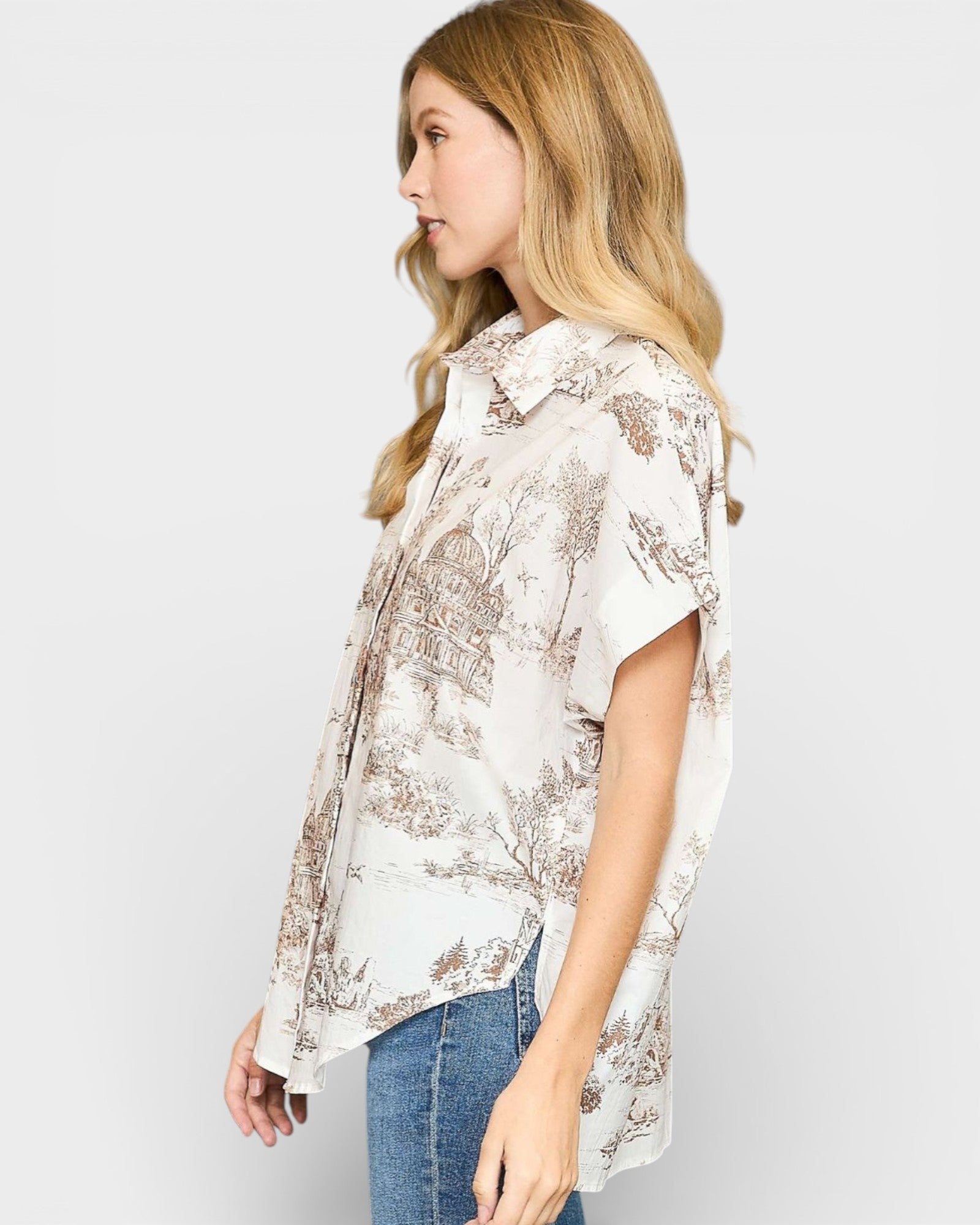 Woman wearing a floral blouse and jeans on a white background