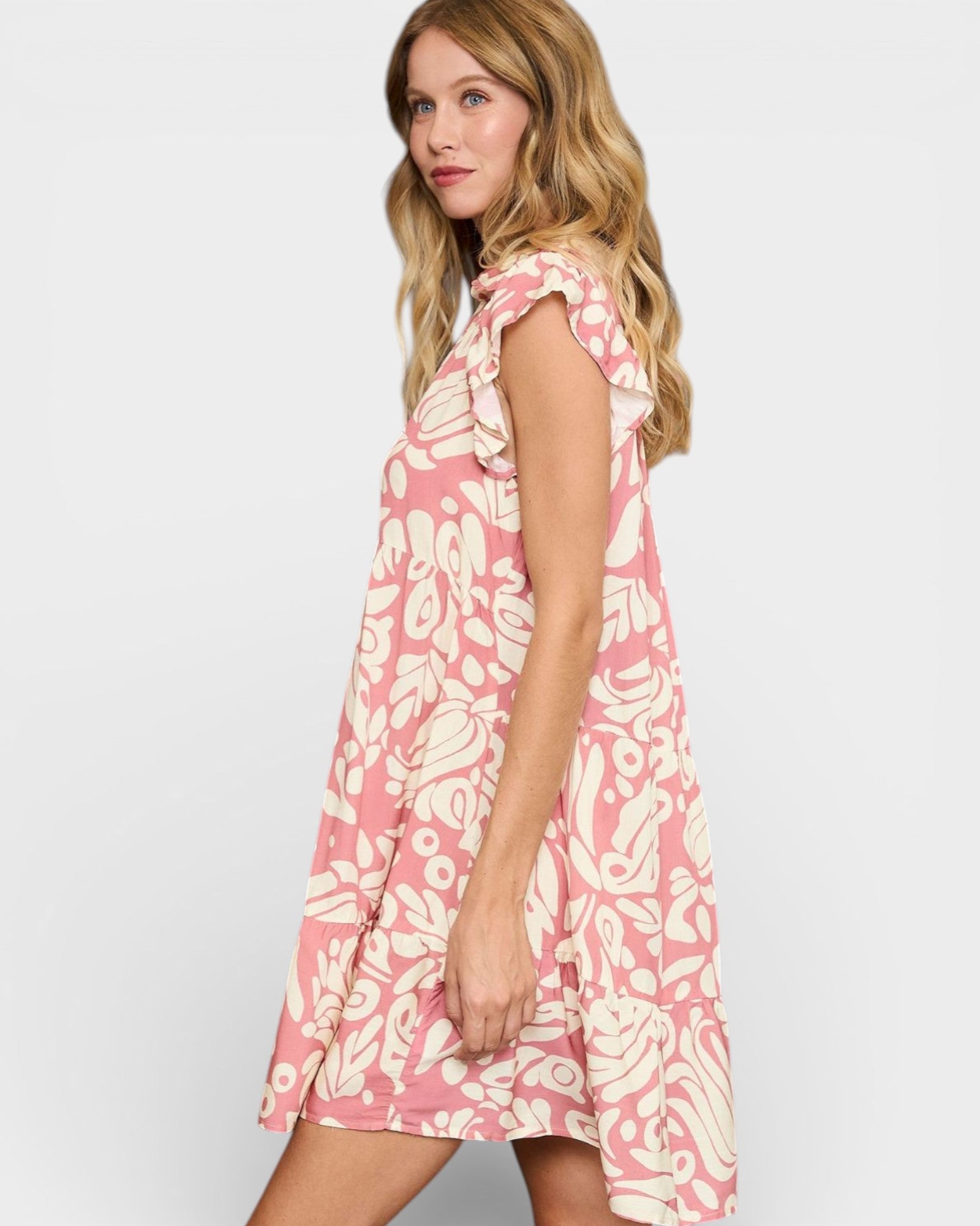 Woman wearing a pink floral dress on a white background