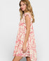 Woman wearing a pink floral dress on a white background