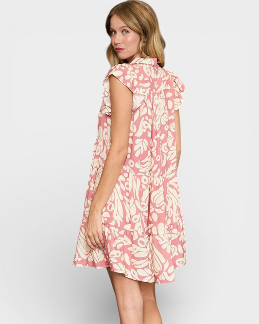 Woman wearing a pink floral dress on a white background