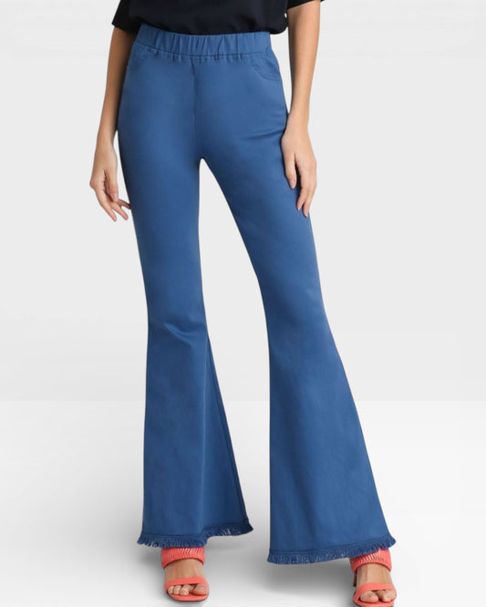 Blue flared pants worn by a person on a white background