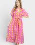 Woman wearing a pink and yellow patterned dress on a white background