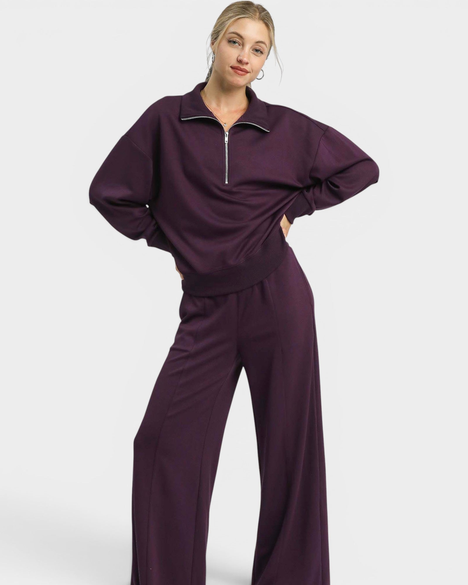 Person wearing a purple tracksuit on a white background