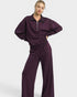 Person wearing a purple tracksuit on a white background