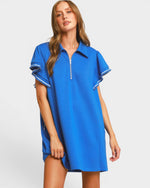 Woman wearing a blue dress with a white background