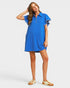 Woman wearing a blue dress with white accents on a white background