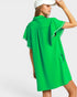 Woman wearing a green dress with white trim on a white background