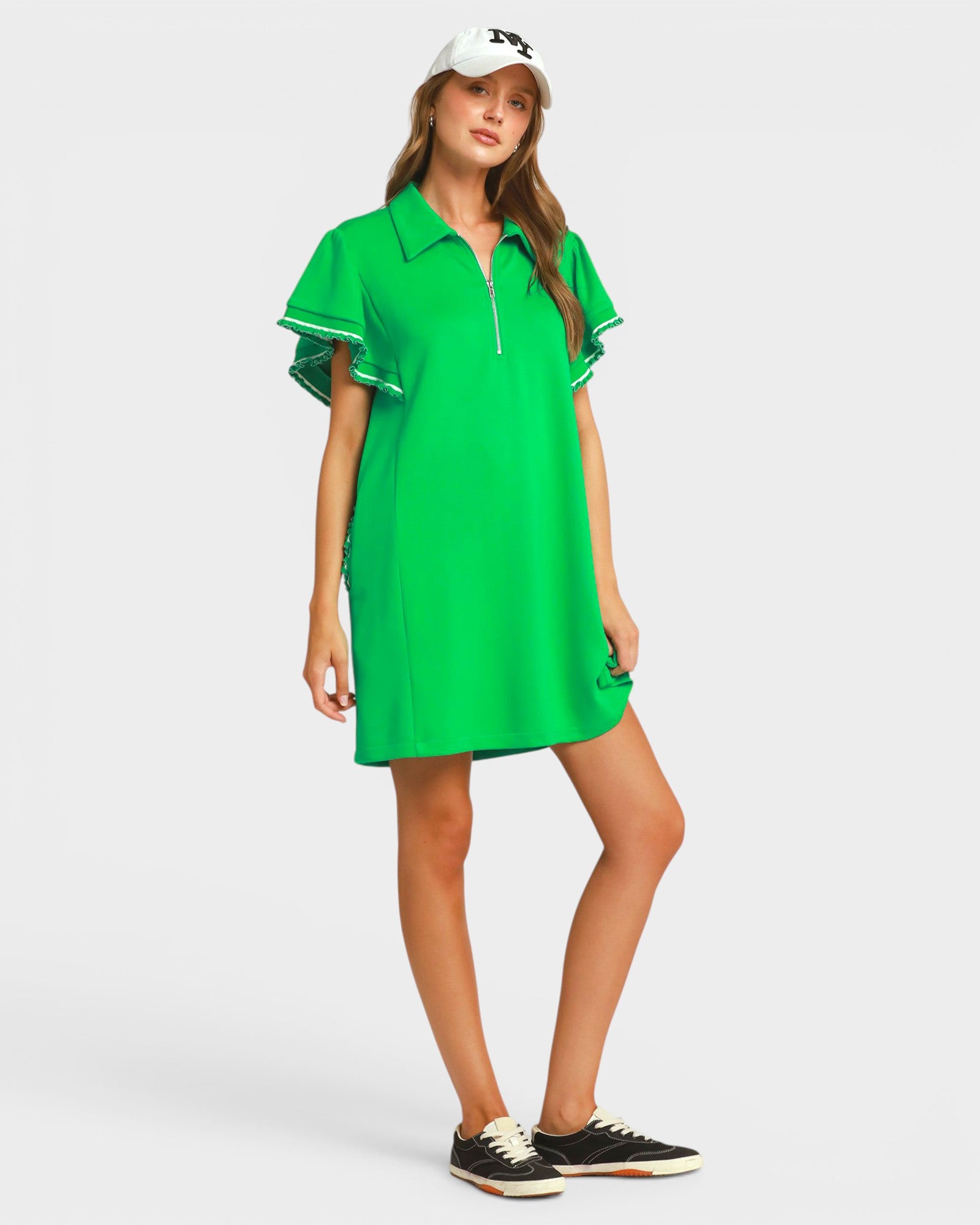 Woman wearing a green dress on a white background
