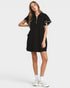 Woman wearing a black dress with white accents on a white background