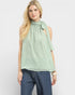 Woman wearing a light green sleeveless top with a bow detail on a white background