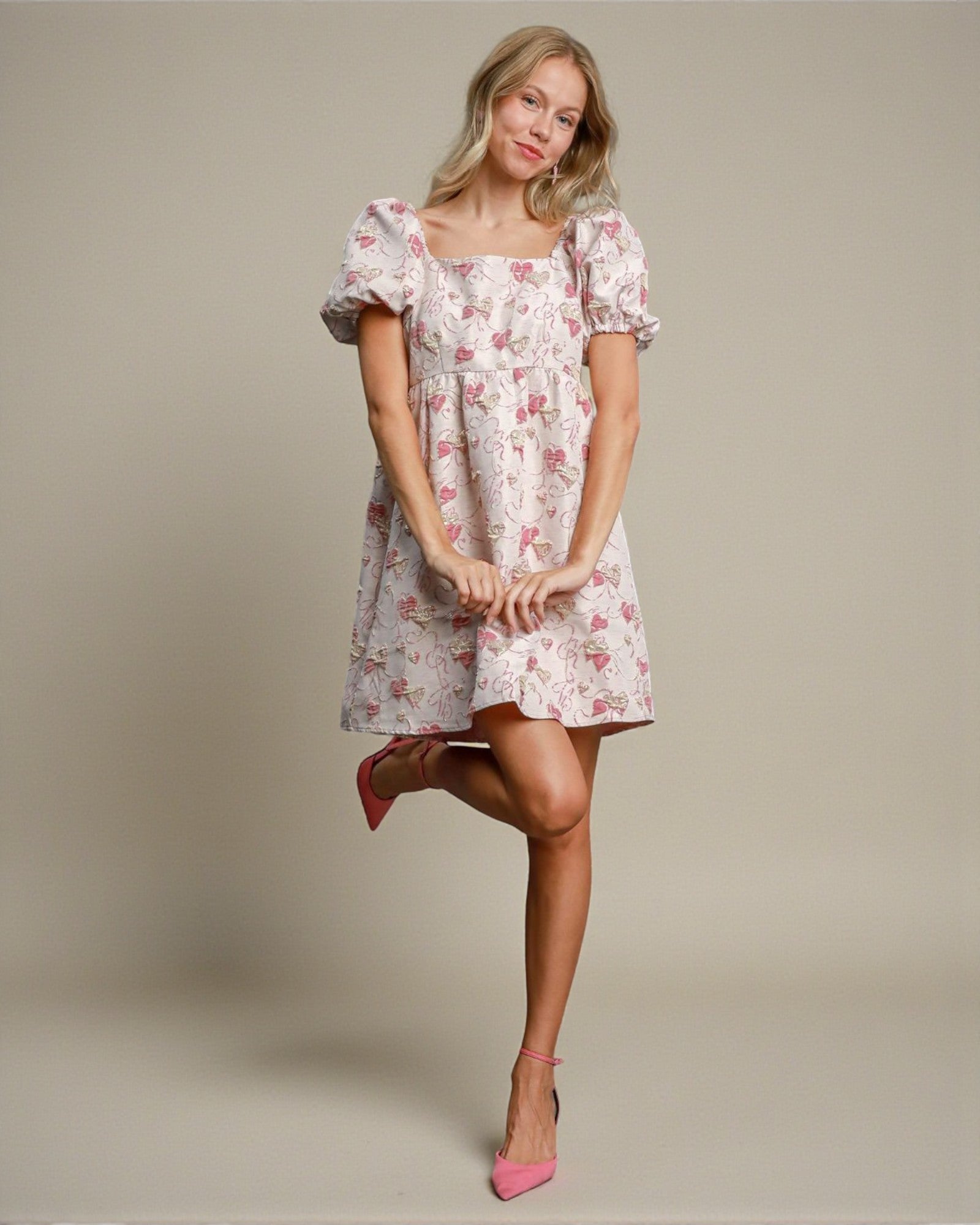 Woman wearing a floral dress on a plain background