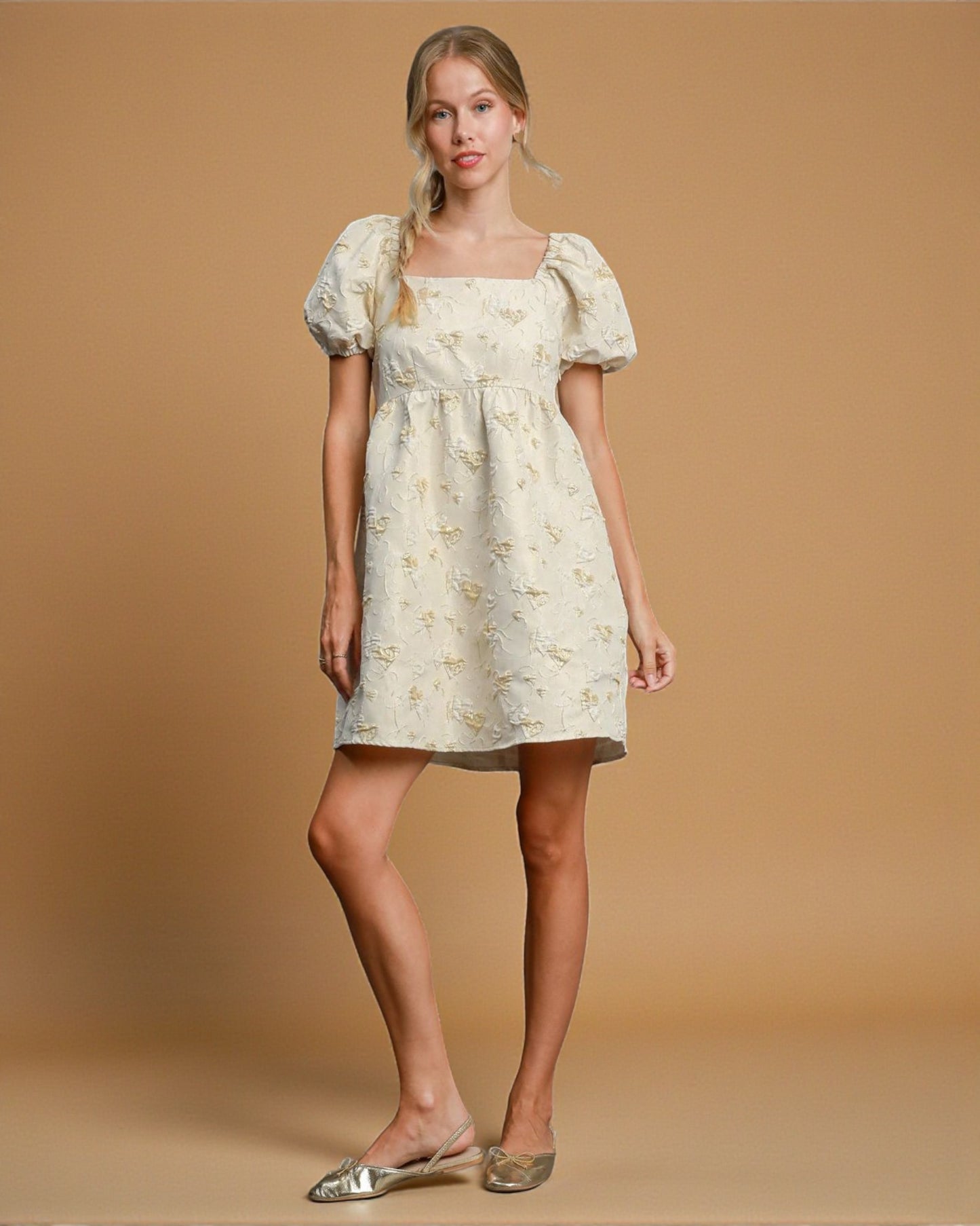 Woman wearing a floral dress against a beige background