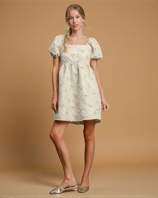 Woman wearing a floral dress against a beige background