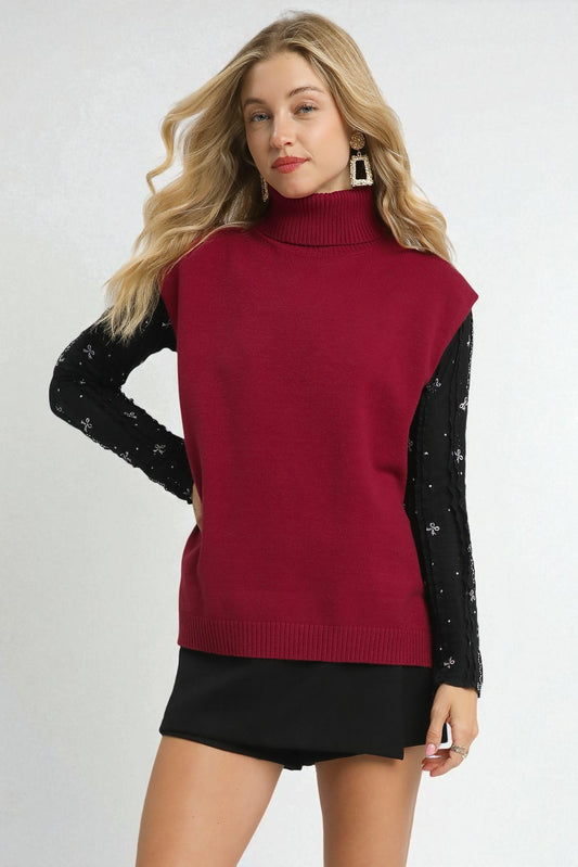 Woman wearing a red sweater with black sleeves on a white background