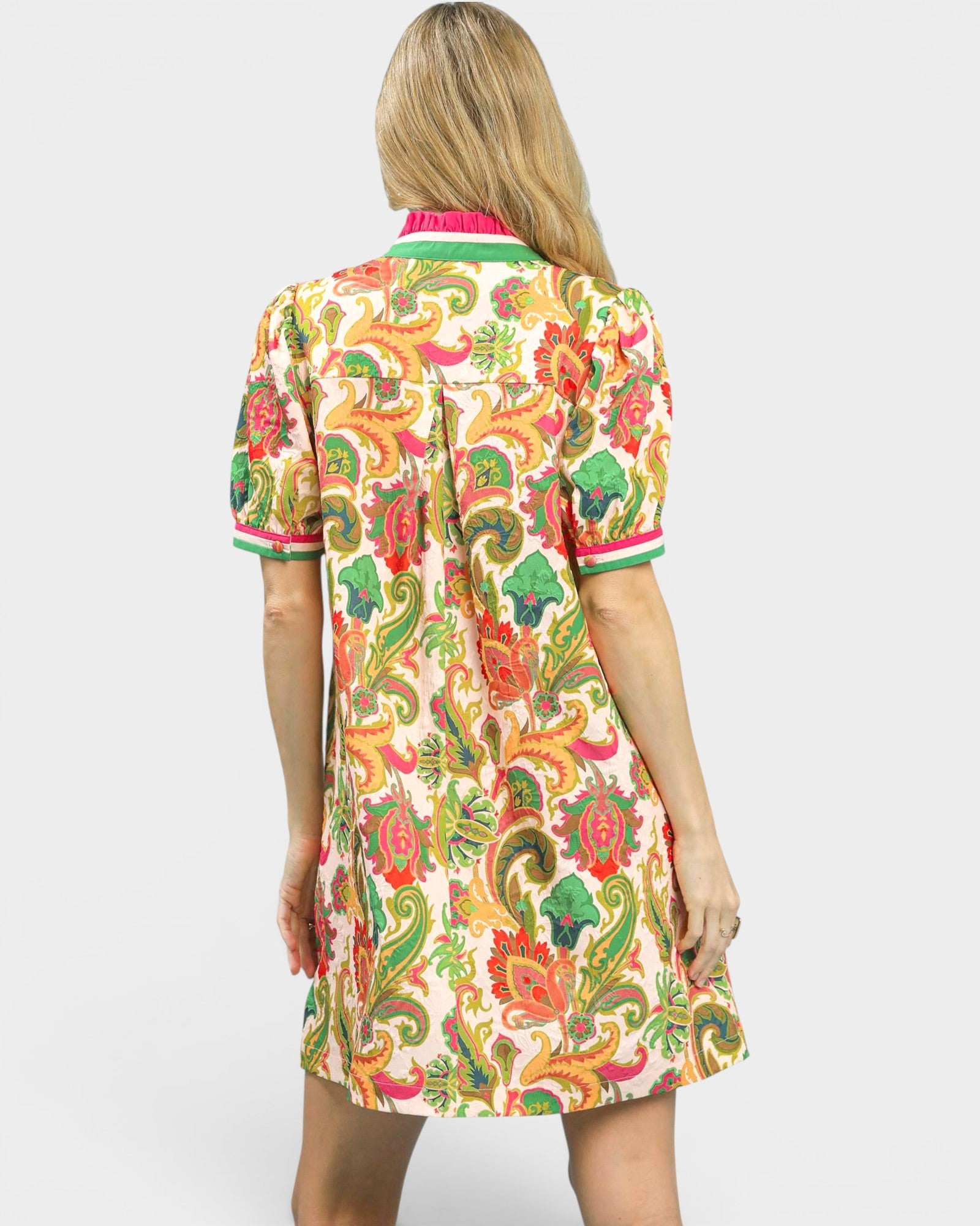 Woman wearing a colorful patterned dress on a white background