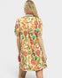 Woman wearing a colorful patterned dress on a white background