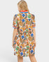 Woman wearing a colorful patterned dress on a white background