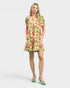 Woman wearing a colorful floral dress on a white background