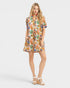 Woman wearing a colorful patterned dress on a white background