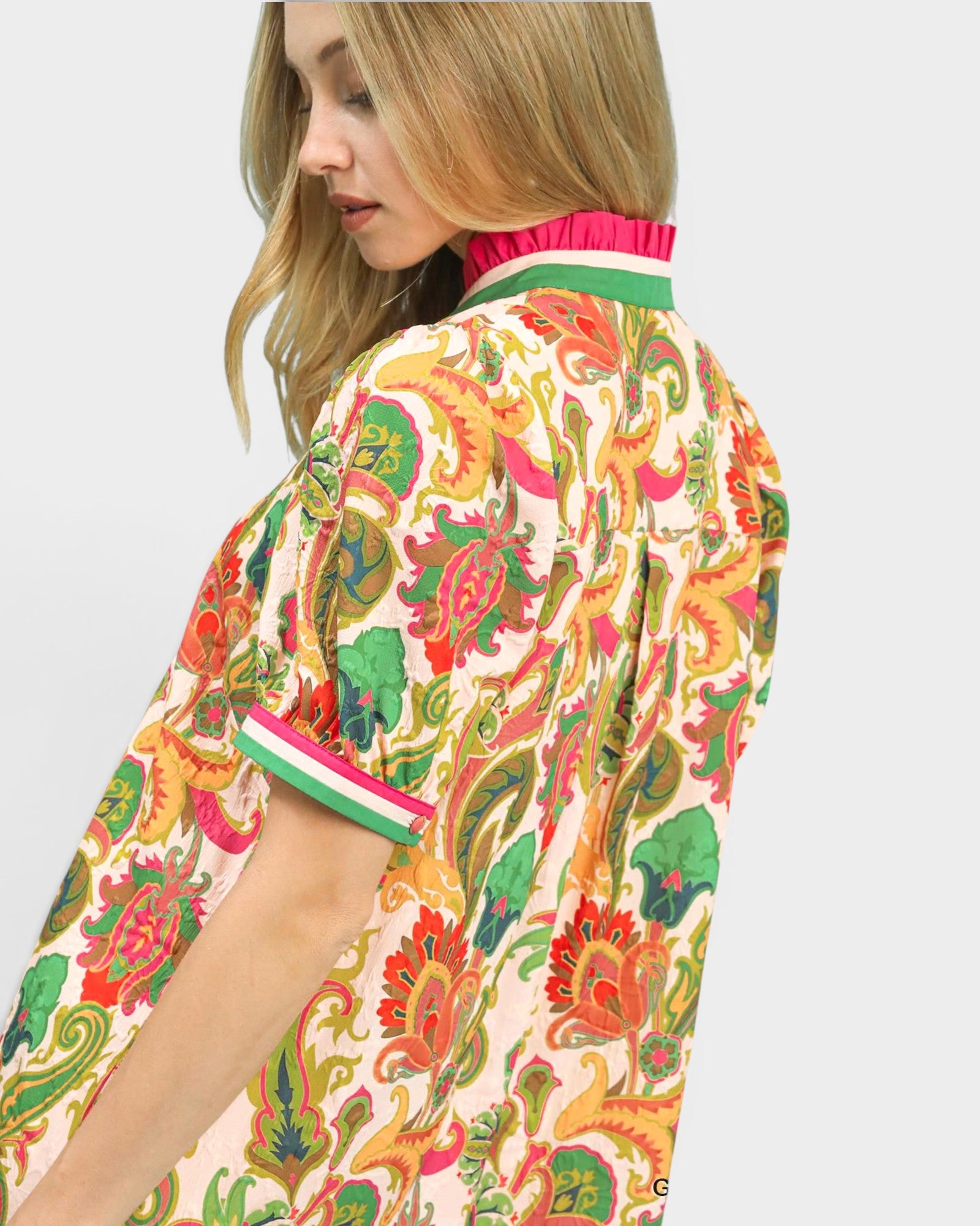 Woman wearing a colorful patterned kimono-style garment on a white background
