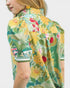 Woman wearing a colorful floral jacket on a white background