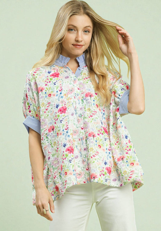 Woman wearing a floral blouse with a light green background