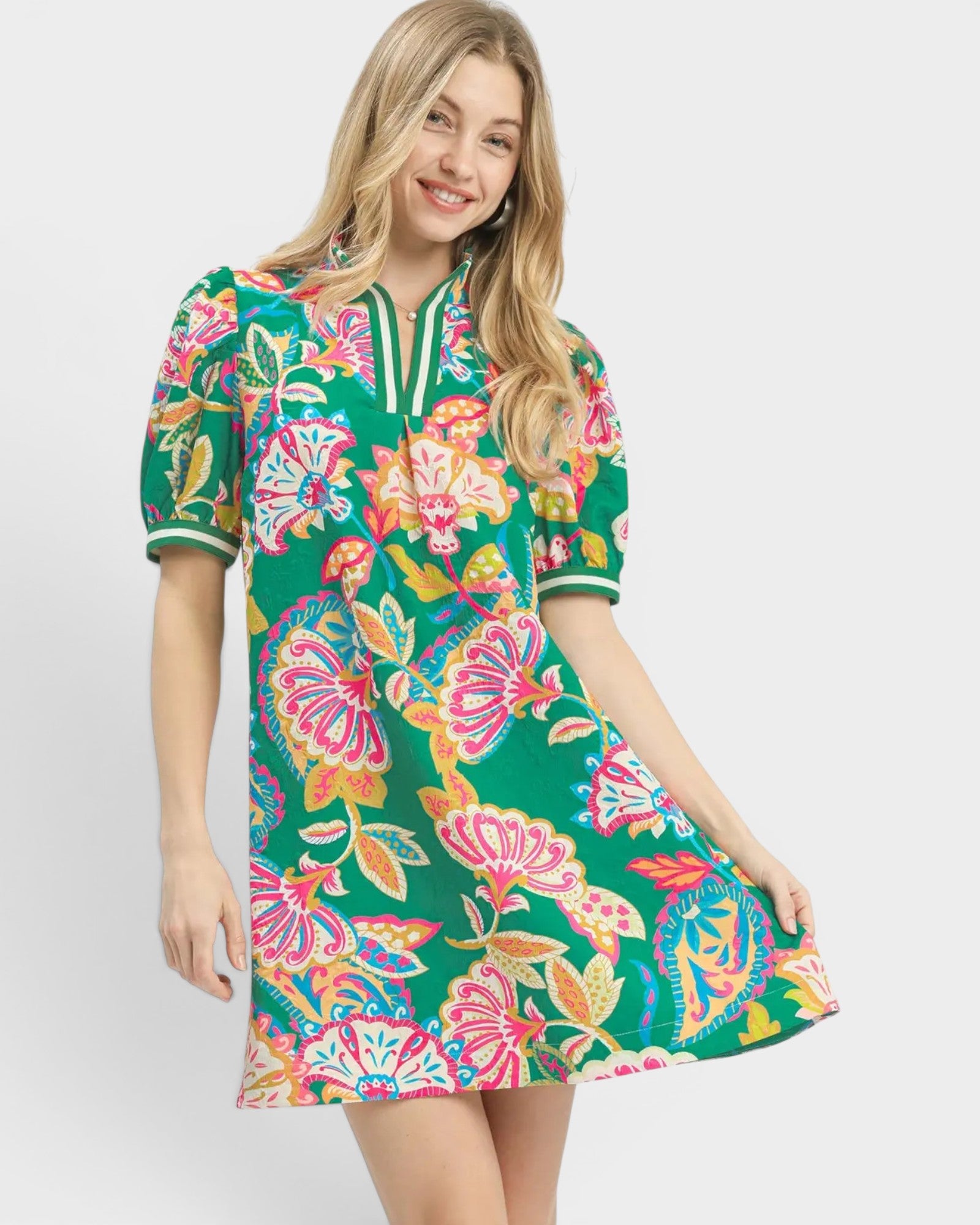 Woman wearing a colorful floral dress on a white background