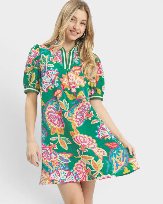 Woman wearing a colorful floral dress on a white background