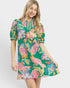 Woman wearing a colorful floral dress on a white background
