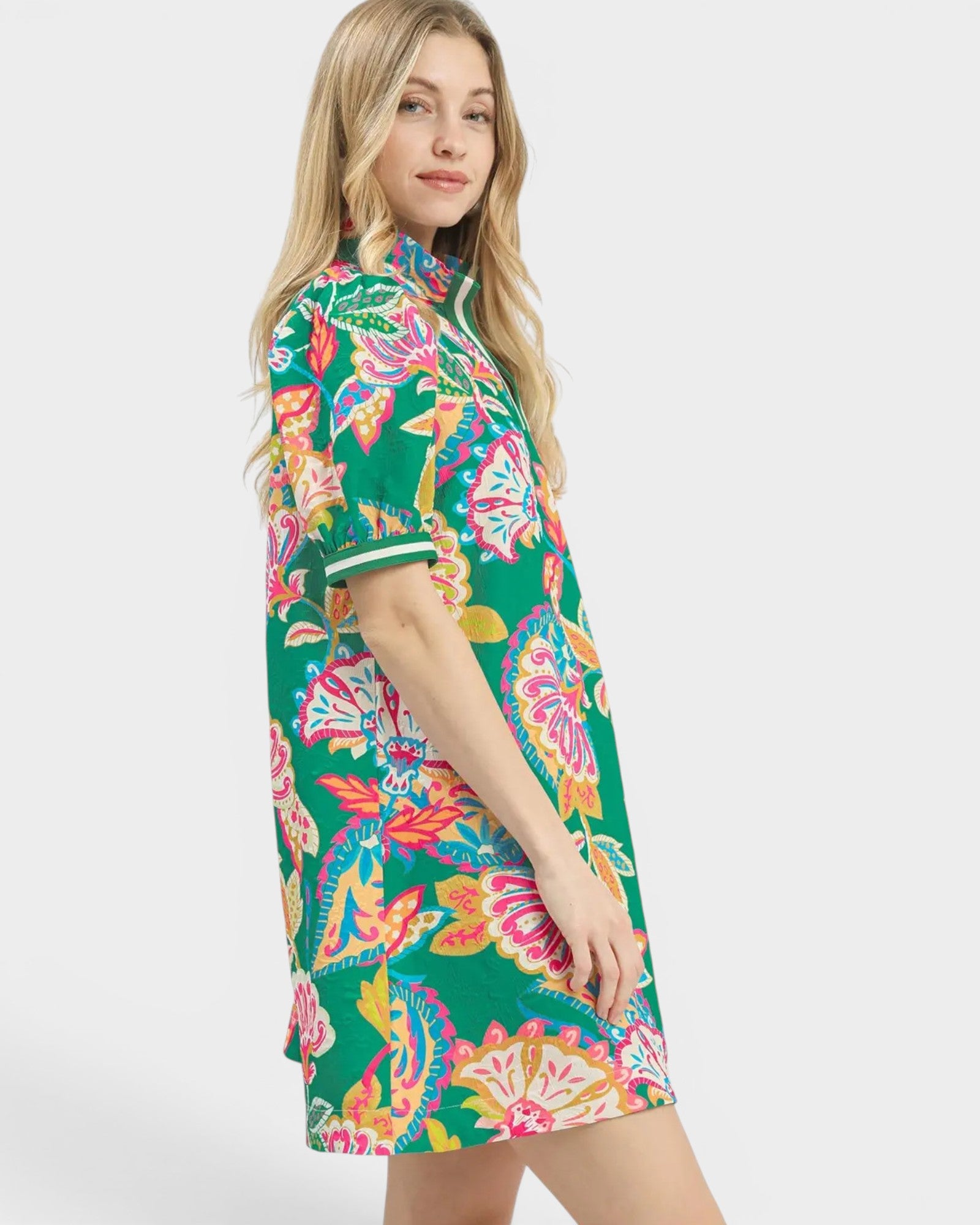 Woman wearing a colorful floral dress on a white background
