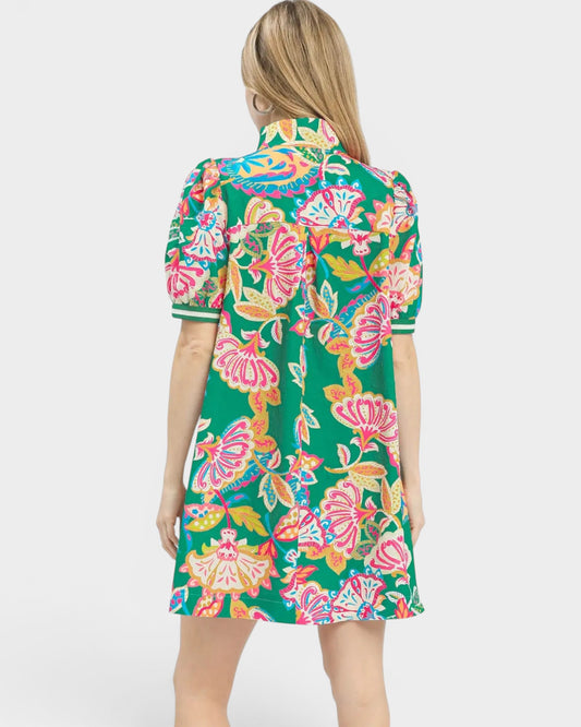Woman wearing a colorful floral dress on a white background