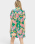 Woman wearing a colorful floral dress on a white background