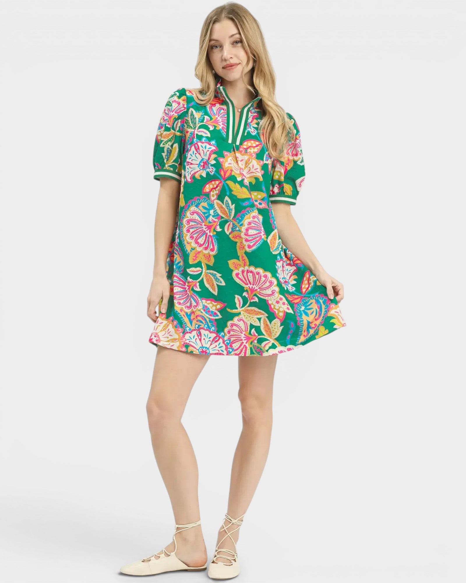Woman wearing a colorful floral dress on a white background