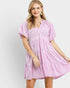 Woman wearing a pink dress with a white background