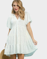 Woman wearing a white dress with a plain background