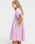 Woman wearing a pink dress with a white background