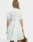 Woman wearing a white dress with a white background