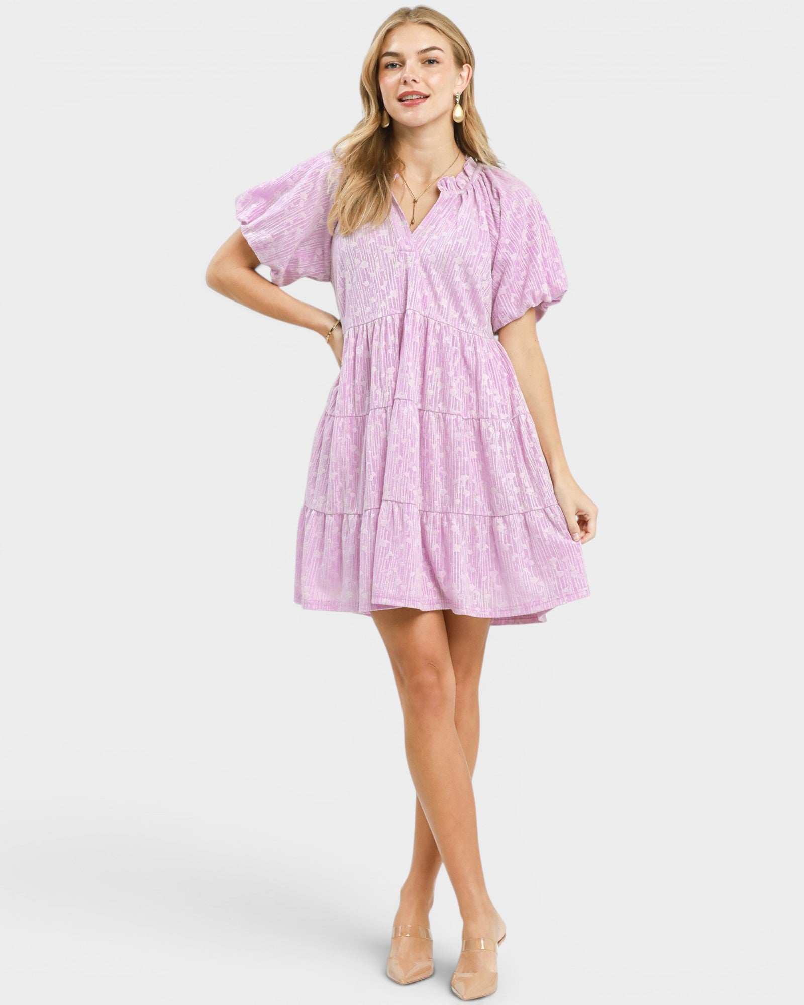 Woman wearing a pink dress on a white background